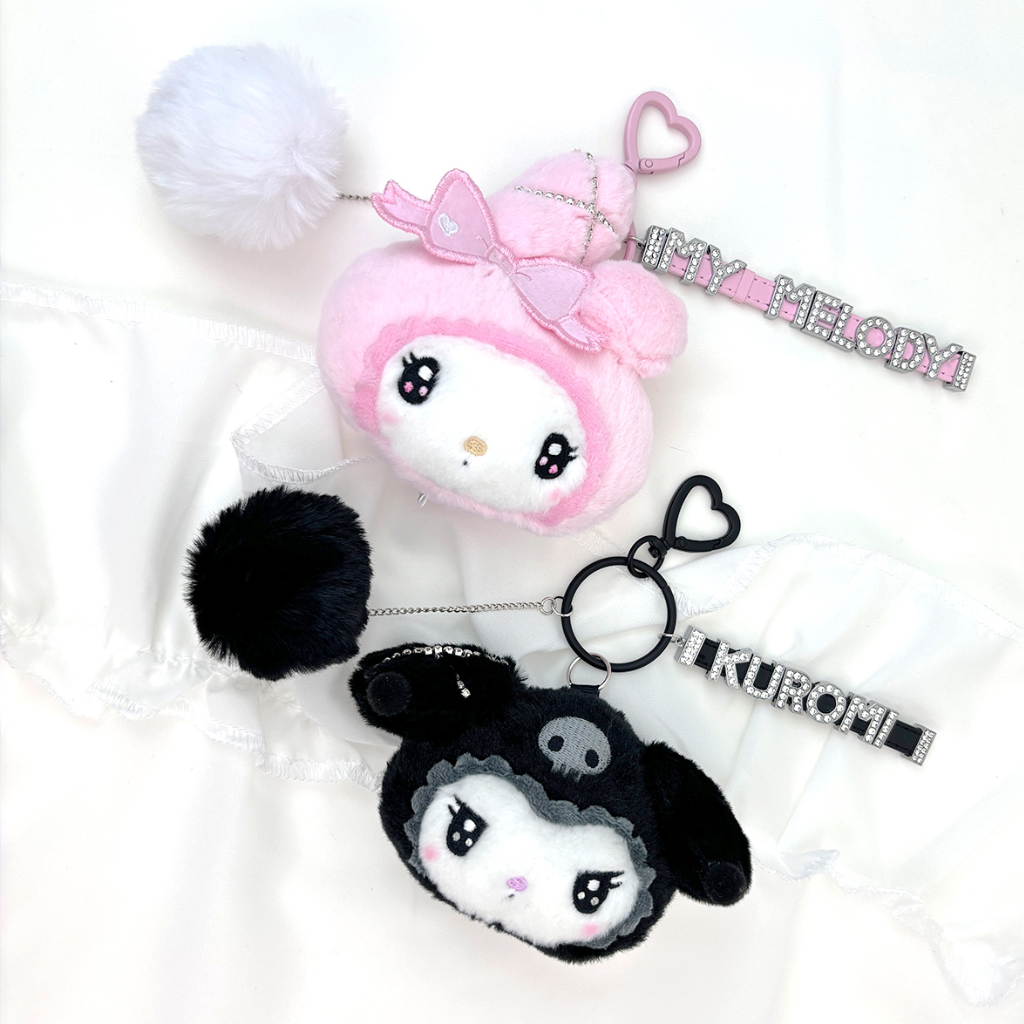 It features an iconic pair of Sanrio characters in a stylish black-and-white theme, with alphabet detailing. 